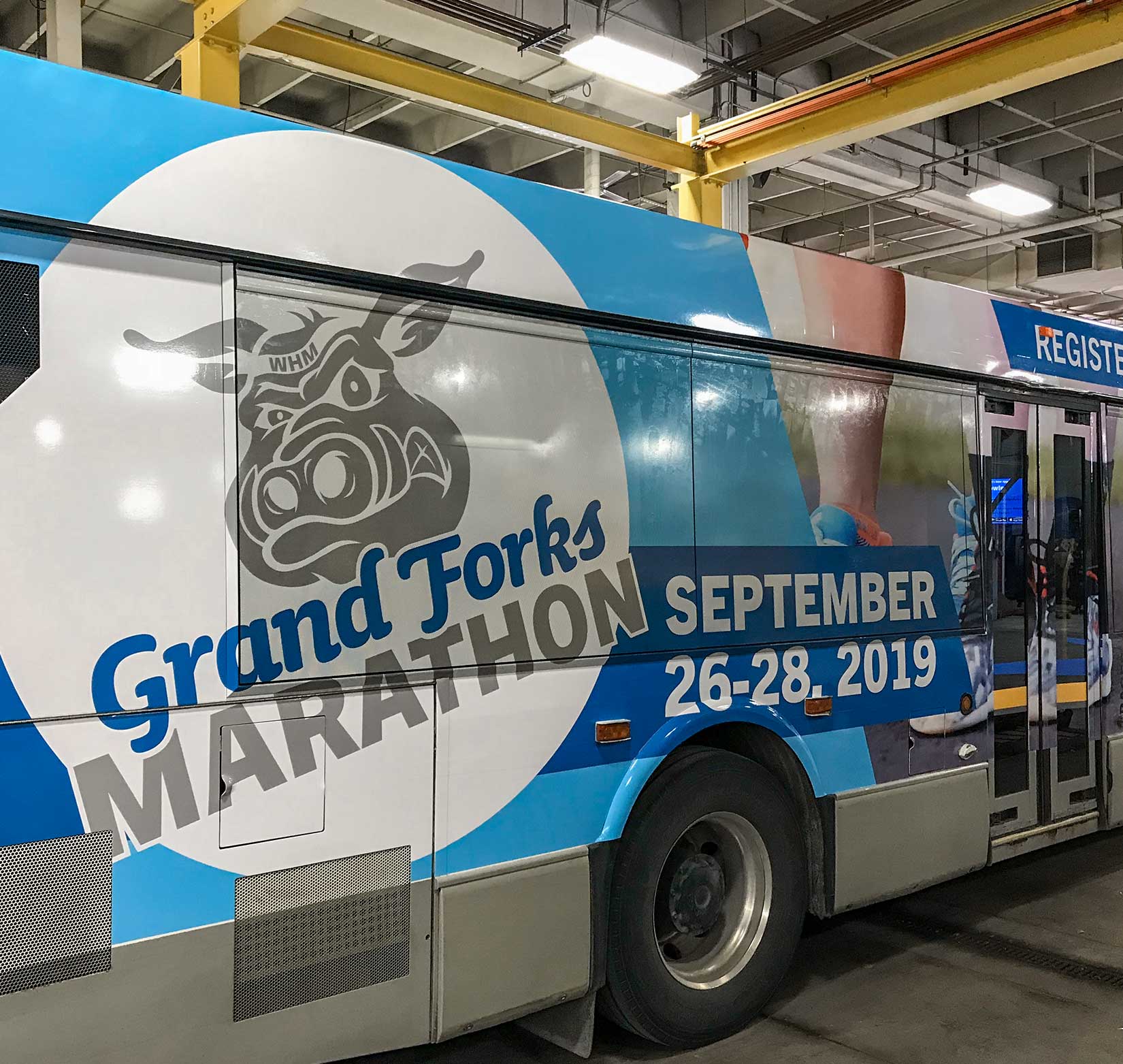 A vinyl bus wrap to promote the 2019 Grand Forks Marathon