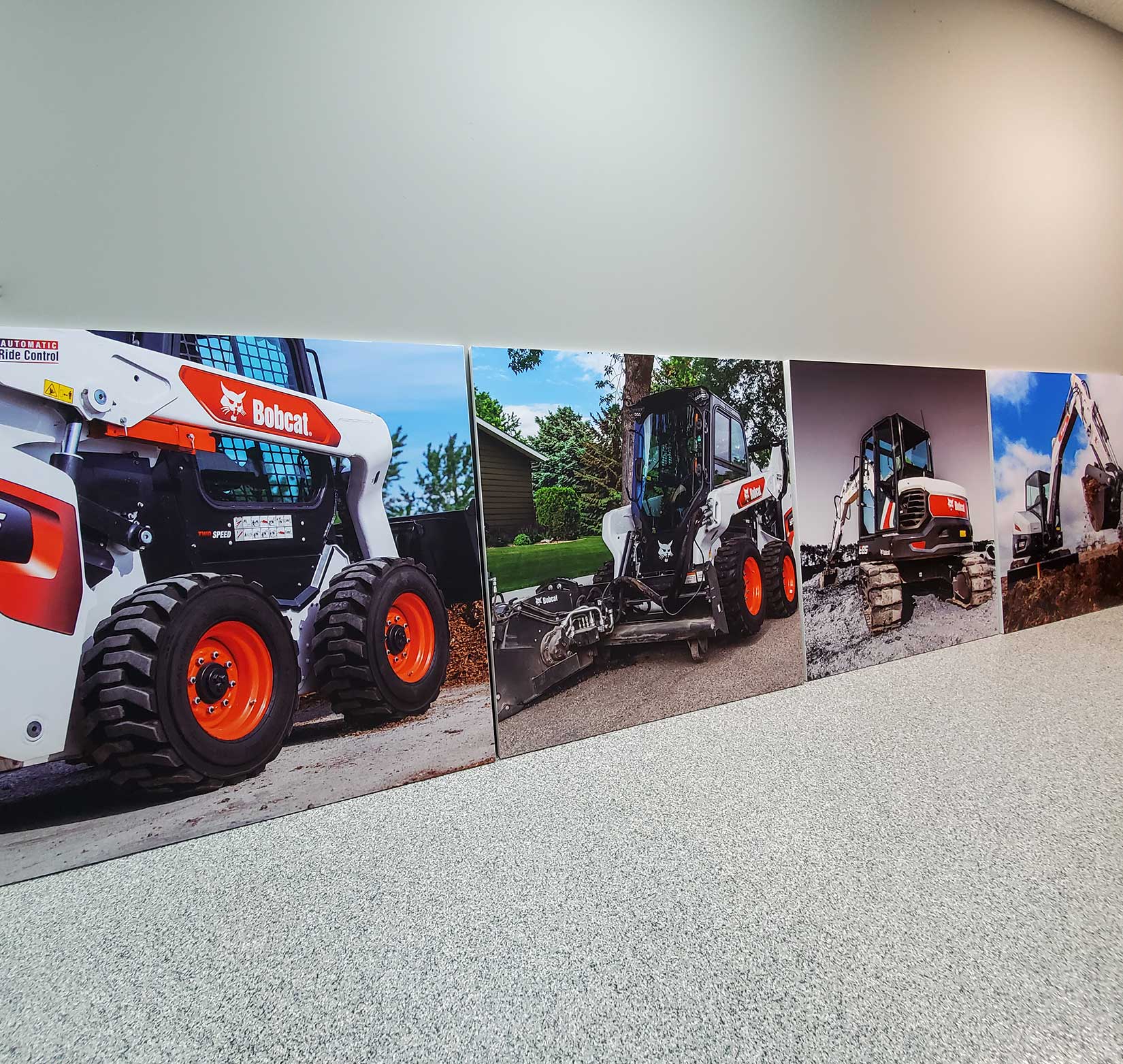 Four large interior posters of Bobcat machinery