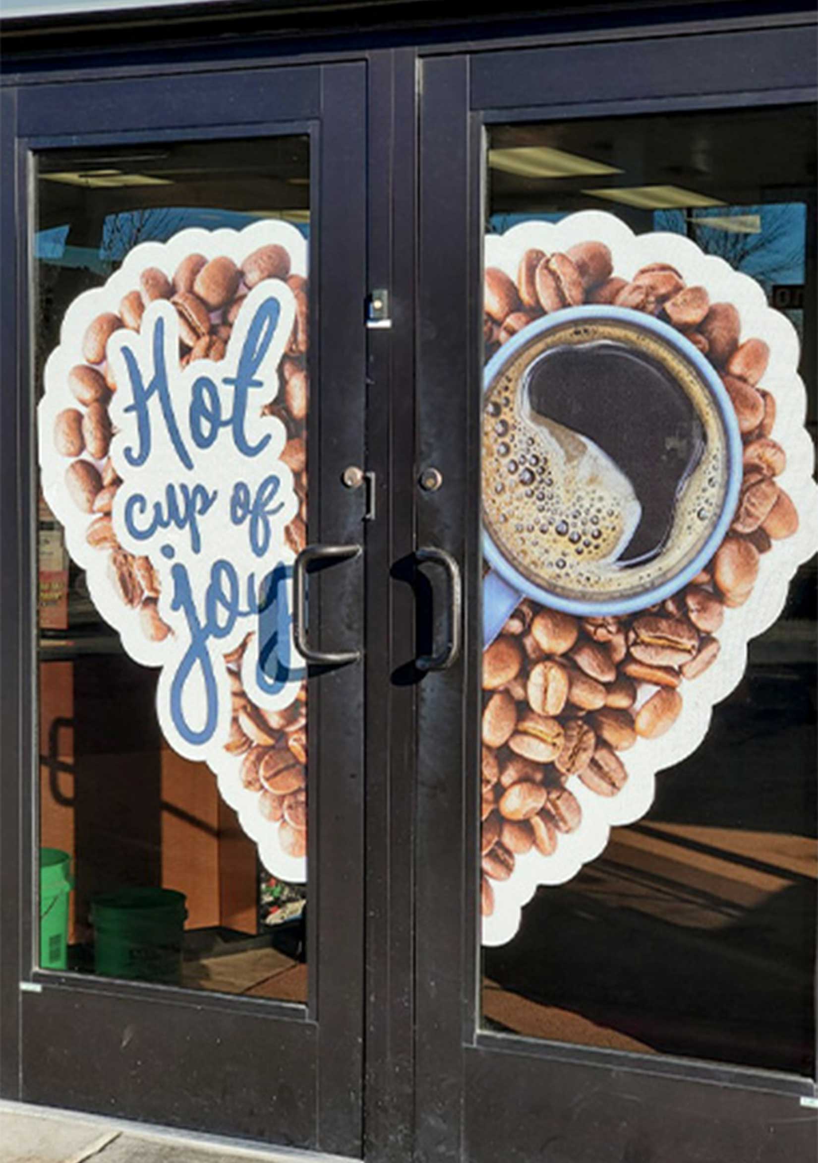 Exterior vinyl signs promoting coffee on the glass doors at Dusterhoft Family Stores