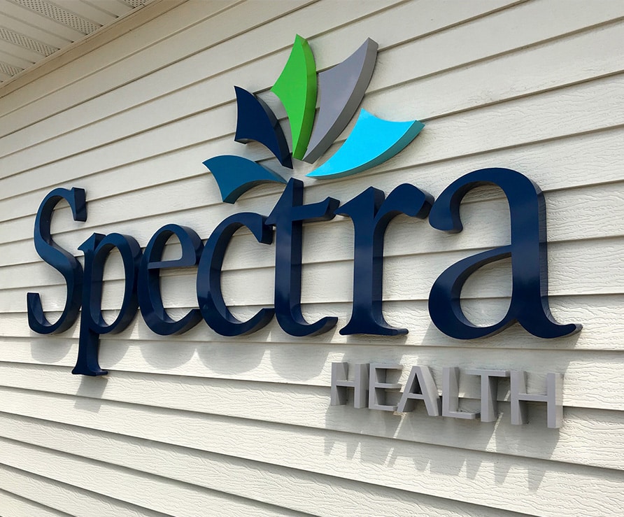 An exterior sign for Spectra Health in Grand Forks, ND