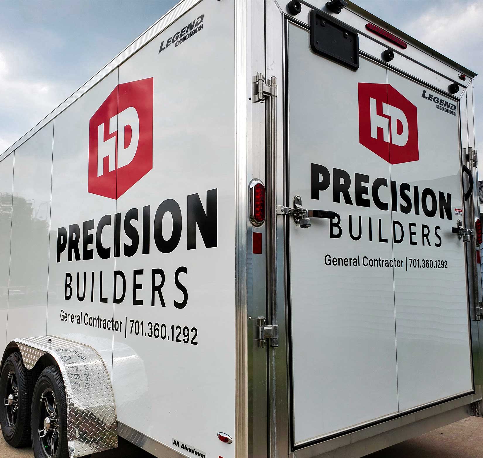 Vinyl lettering on a white trailer for Precision Builders
